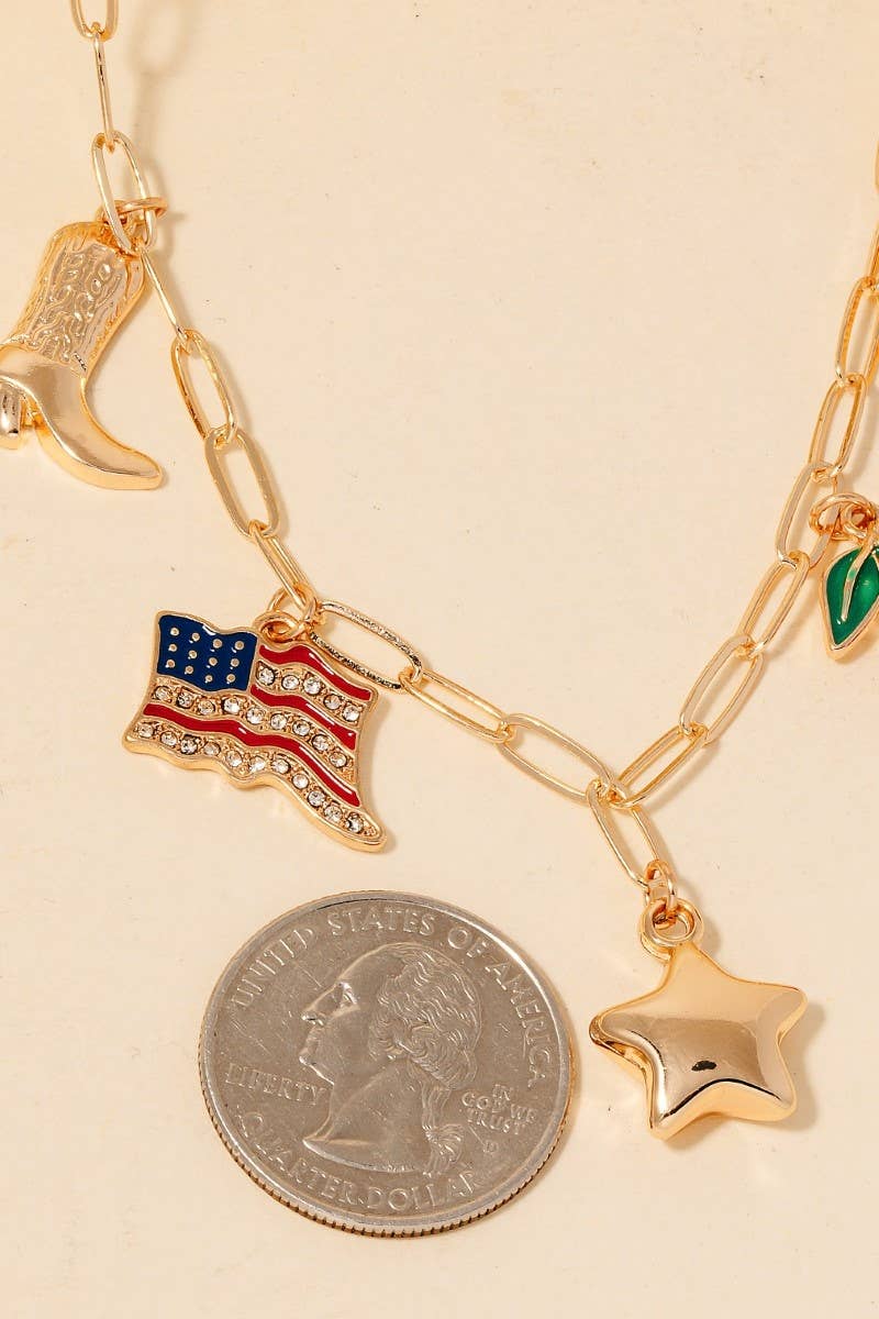 A close-up of the gold chain necklace, showcasing the intricate details of the American flag charm alongside a standard quarter coin for size reference.