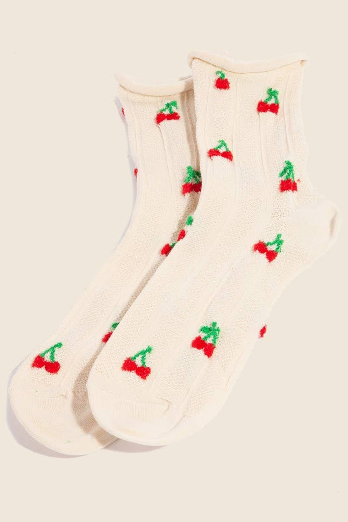 Pair of beige socks with cherry embroidery displayed flat, highlighting the playful cherry pattern and the soft, ribbed texture.