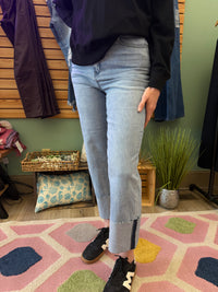 Close-up of high-waisted straight-leg boyfriend jeans in light denim, featuring a relaxed fit and stylish cuffed hems. Perfect for casual-chic outfits