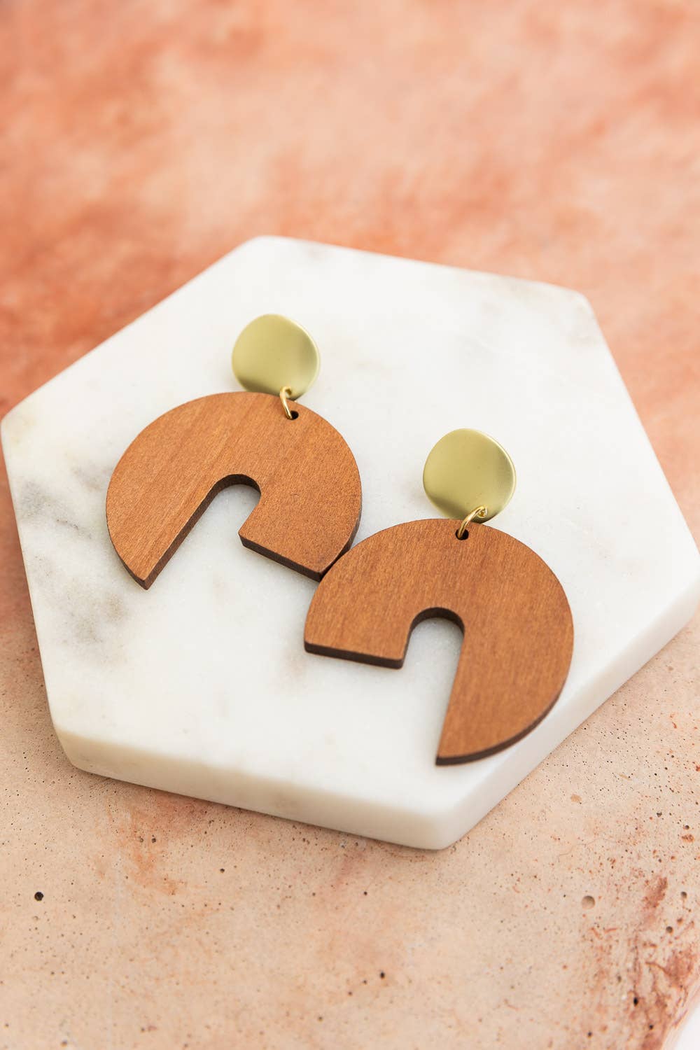 wooden modern arch earrings on display stand