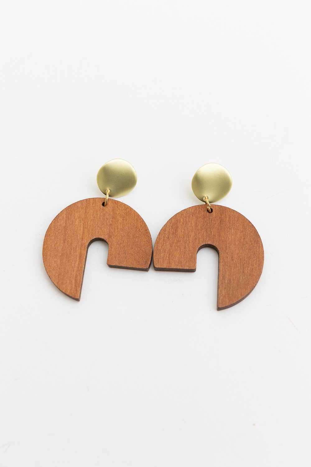wooden modern arch shaped earrings on white background