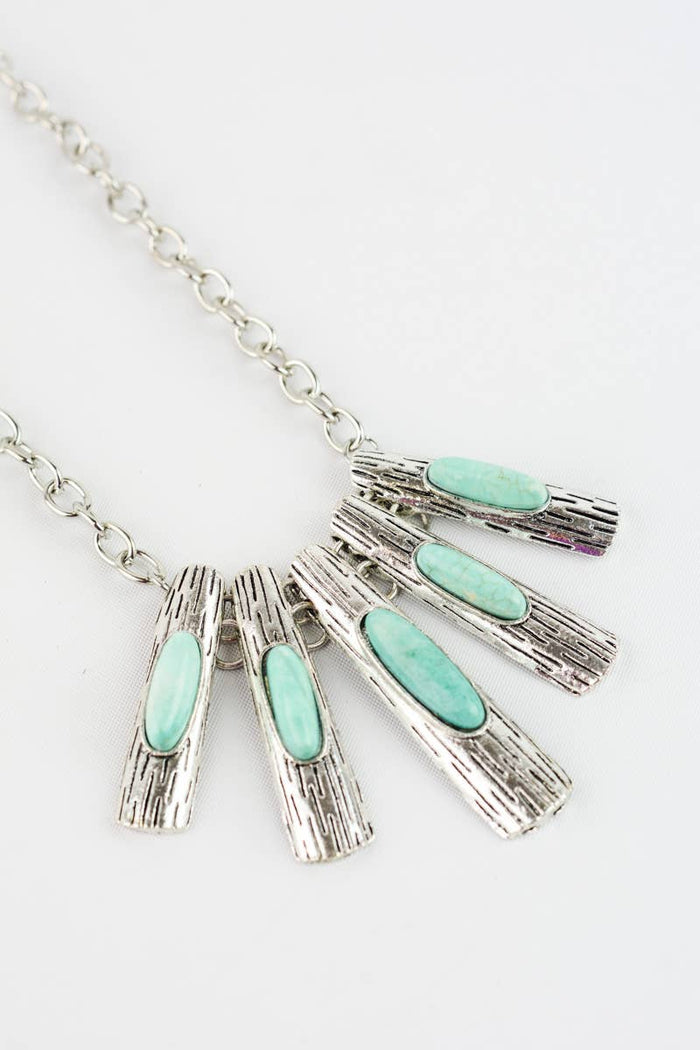 Close up of Five piece silver and turquoise pendant necklace