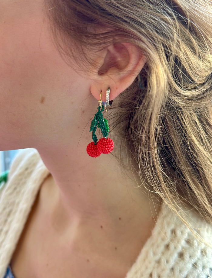 Side view of Cherry dangle earrings on women’s ear