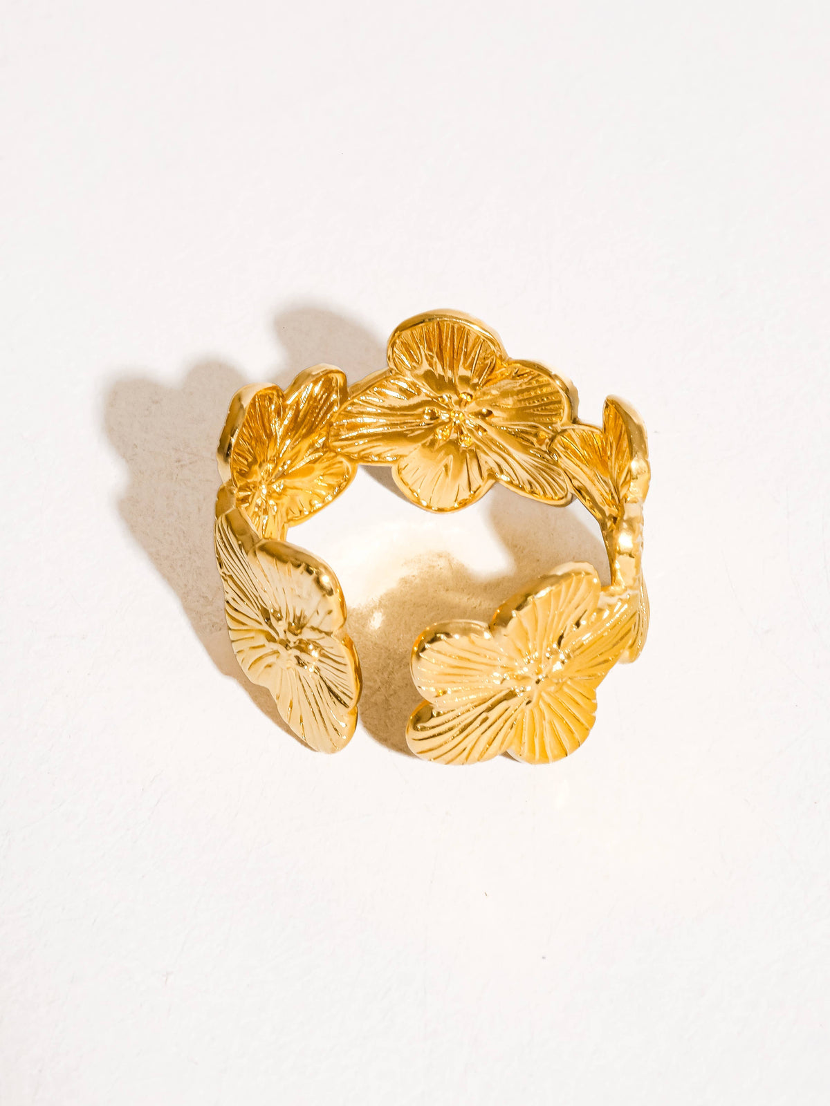 Gold adjustable floral ring featuring detailed hibiscus-inspired petals