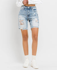 Super high-rise, distressed Bermuda jean shorts up close front