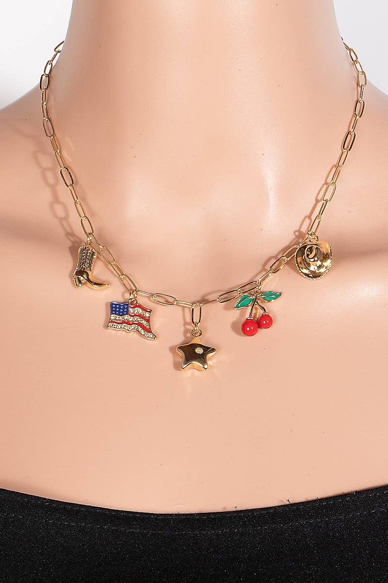  A gold chain necklace adorned with charming pendants including a cowboy boot, American flag, star, cherries, and a cowboy hat, displayed on a mannequin for a stylish touch.