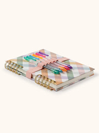 Colorful argyle notebook with gold split-spiral binding and attached gel pens