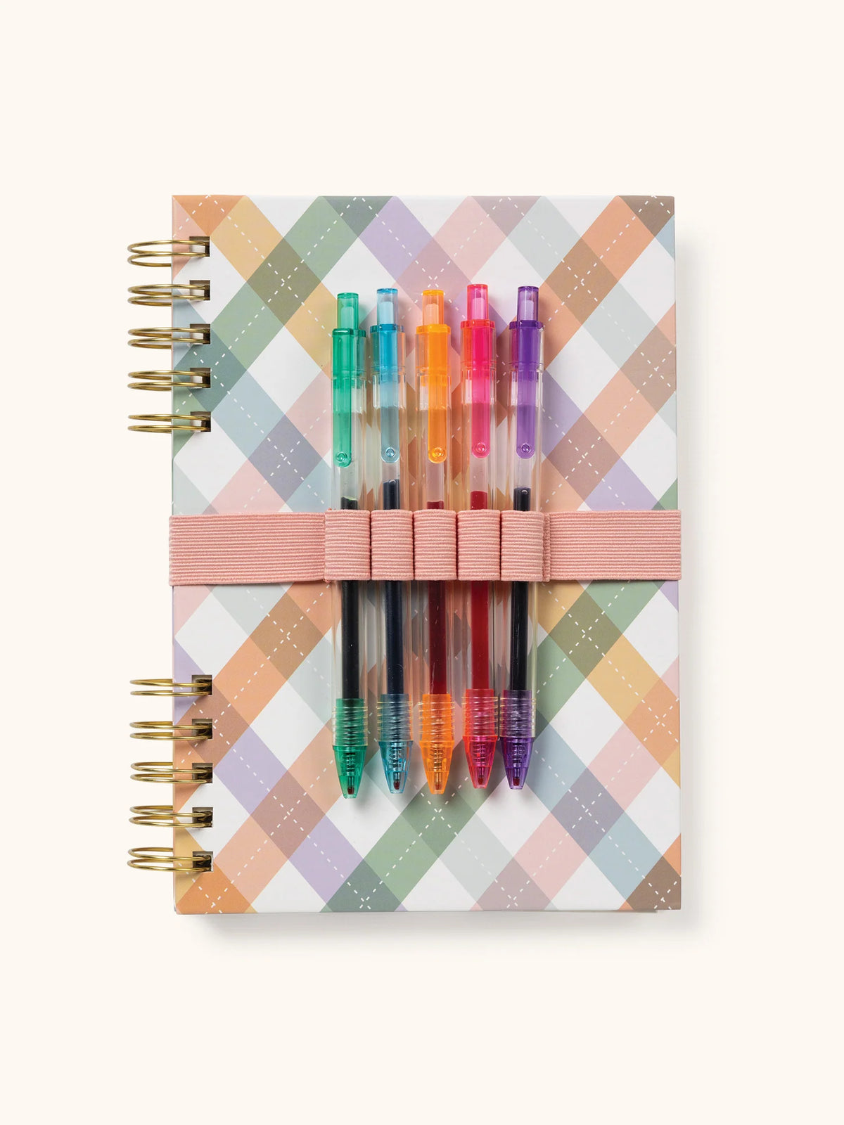 Close-up of elastic pen holder with five vibrant gel pens on an argyle notebook