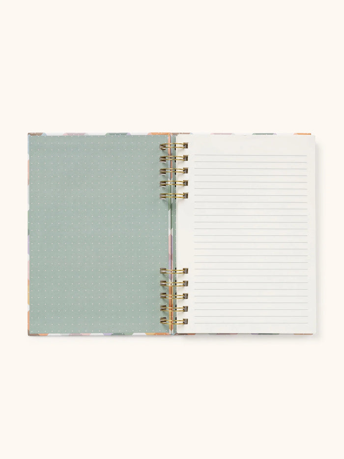 Open notebook with lined pages and a stylish patterned interior cover