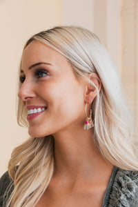 Coastal chic tassel hoop earrings on side view of model