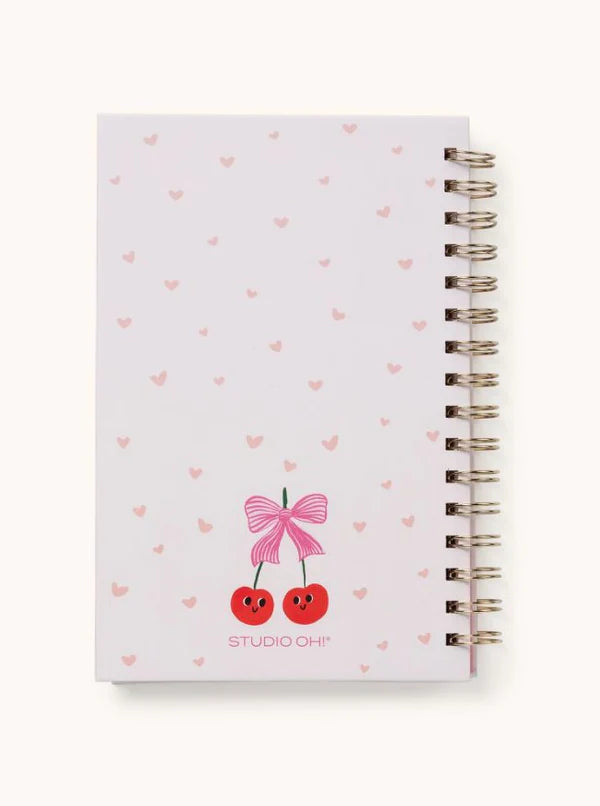 Back cover of the cherry-themed notebook with soft pink heart details and spiral binding.